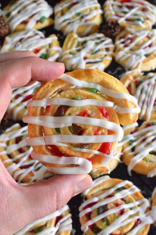 One of my favourite Christmas ingredients is being put to great use today! Cherry Pinwheel Cookies are made with a light, biscuit-like dough and rolled with red and green candied cherries. Drizzled with a basic sweet icing, these are absolutely delicious and very festive too! #christmas #holiday #baking #cherries #candiedcherries #cherry #redandgreen #drizzle