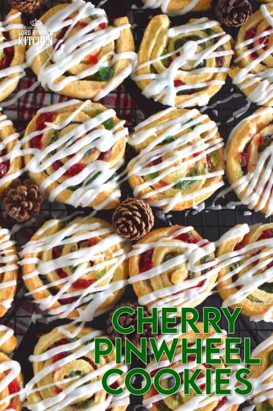 One of my favourite Christmas ingredients is being put to great use today! Cherry Pinwheel Cookies are made with a light, biscuit-like dough and rolled with red and green candied cherries. Drizzled with a basic sweet icing, these are absolutely delicious and very festive too! #christmas #holiday #baking #cherries #candiedcherries #cherry #redandgreen #drizzle