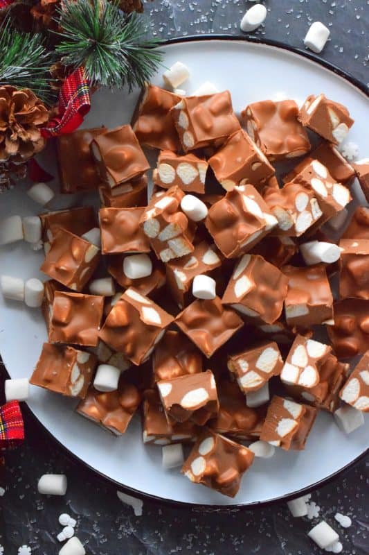 In all probability, this will be the best thing you will eat this holiday season. No Bake Chocolate Marshmallow Squares are prepared with only four ingredients and comes together in just minutes with the help of a microwave. These are decadent and rich, and you won't be able to stop eating them! #christmas #holidays #chocolate #nobake #peanutbutter #treats