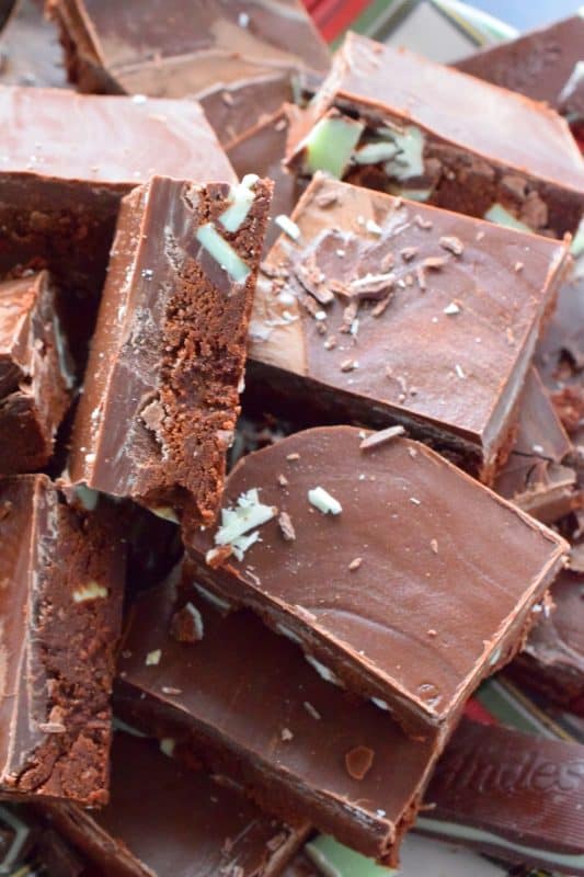 This no-bake fudge recipe is packed full of chopped Andes Mints and is prepared with peppermint extract. The chocolate topping is made with melted Andes Mints too, so you know this fudge is for the extreme mint lover! #andes #mints #peppermint #chocolate #fudge