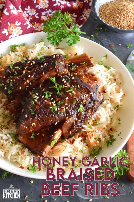 Pan-seared beef ribs are braised in a honey garlic sauce prepared with red wine. These moist and tender ribs are perfect for a cold winter night's dinner. Serve with hearty polenta or mashed potatoes and be sure to ladle on some of that thick, glossy, sweet, and garlicky sauce! #beef #beefribs #shortribs #honeygarlic #dutchoven #braised