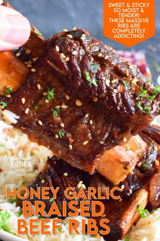Pan-seared beef ribs are braised in a honey garlic sauce prepared with red wine. These moist and tender ribs are perfect for a cold winter night's dinner. Serve with hearty polenta or mashed potatoes and be sure to ladle on some of that thick, glossy, sweet, and garlicky sauce! #beef #beefribs #shortribs #honeygarlic #dutchoven #braised