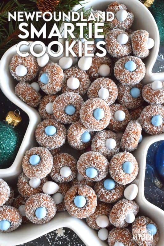 Prepared with melted marshmallows, cocoa, and graham crumbs, Newfoundland Smartie Cookies are sure to give you smores vibes. The addition of the candy coated chocolate in the center helps to make this cookie feel and look more festive. #smarties #newfoundland #christmas #nobake #cookies #newfie