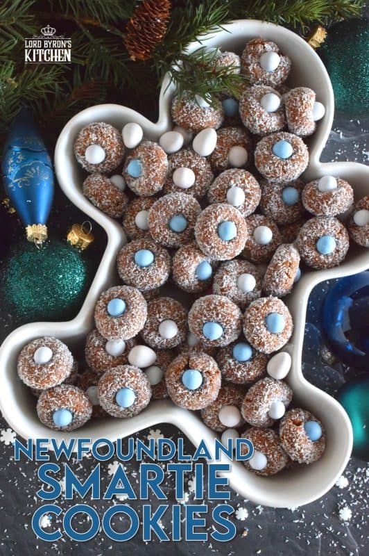 Prepared with melted marshmallows, cocoa, and graham crumbs, Newfoundland Smartie Cookies are sure to give you smores vibes. The addition of the candy coated chocolate in the center helps to make this cookie feel and look more festive. #smarties #newfoundland #christmas #nobake #cookies #newfie