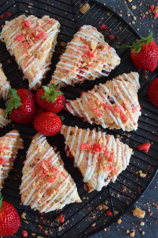 Glazed Strawberry Shortcake Scones have triple the strawberry flavour for the absolute most strawberry-esque scone ever! Packed with real strawberries, strawberry shortcake crumble, and strawberry extract, these are a tasty and delightful sweet treat! #strawberry #shortcake #strawberryshortcake #scones #dried #fresh
