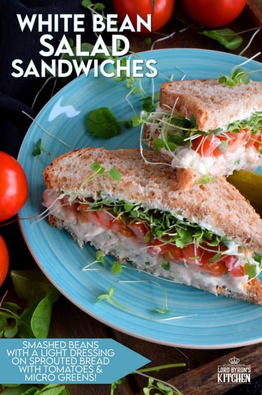 When you mash canned white beans, and combine them with mayo and seasonings, the result is a creamy and tasty vegetarian salad sandwich spread. Top that sandwich with sliced tomatoes, fresh microgreens, and watercress for a very healthy and hearty lunch. #canned #beans #smashed #salad #sandwich #vegetarian #meatless