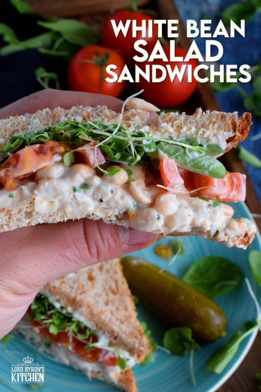 When you mash canned white beans, and combine them with mayo and seasonings, the result is a creamy and tasty vegetarian salad sandwich spread. Top that sandwich with sliced tomatoes, fresh microgreens, and watercress for a very healthy and hearty lunch. #canned #beans #smashed #salad #sandwich #vegetarian #meatless