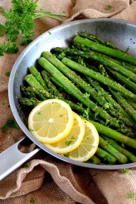 Lemon Butter Asparagus is as simple as it gets - gently sautéed asparagus in a little salted butter with lemon juice, lemon zest, and seasoning. It's a side that is bright and refreshing; a perfect spring and summer side! #asparagus #fresh #saute #skillet #lemon #butter #fried