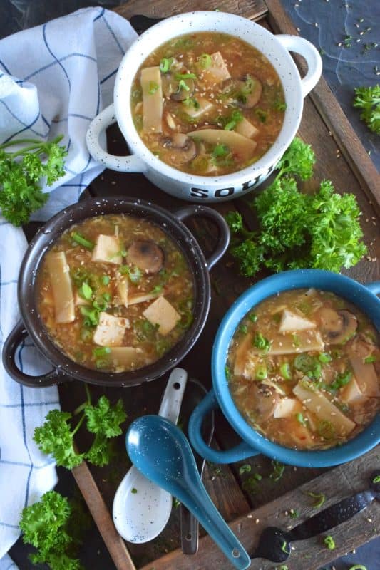 Prepared with mushrooms, bamboo shoots, tofu, and green onions, this 30 Minute Vegetarian Hot and Sour Soup is all you need to keep warm this winter. A popular Chinese buffet starter that everyone loves, this soup is thick and loaded with good-for-you ingredients. #hotandsour #soup #copycat #takeout #tofu