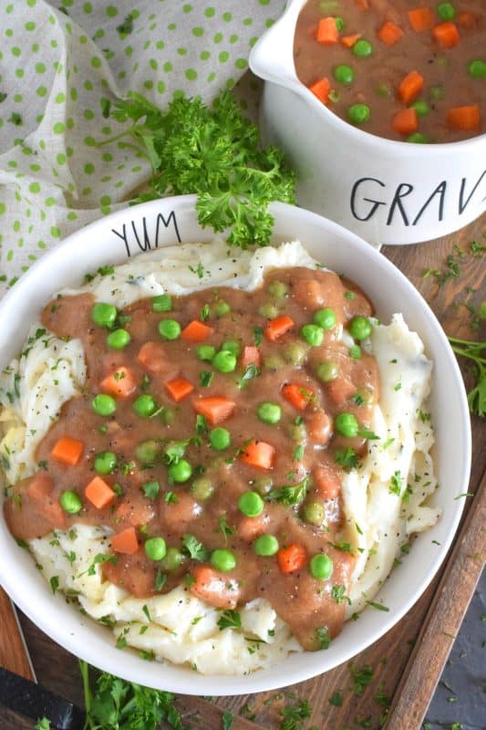 Thick or thin, the choice is yours, but when it comes to Homestyle Gravy with Peas and Carrots, I think thick is best! This easy to make from scratch gravy is deliciously savoury and a perfect vessel to suspend those buttered carrots and peas into! Pour liberally over mashed potatoes and dig in! #gravy #vegetarian #stpattysday #mashedpotatoes