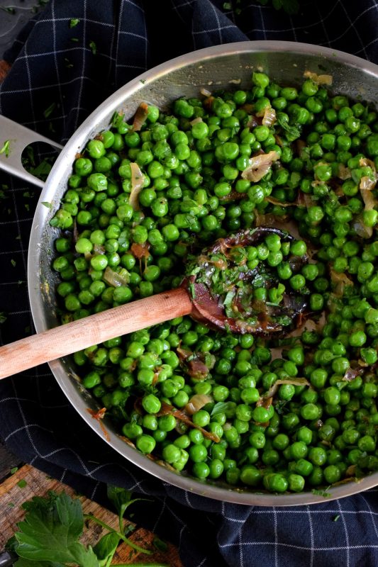 A side dish needn't be complicated and fussy; Sauteed Green Peas is a wonderful side to almost any meal! Just a few basic ingredients, like peas, garlic, and shallots is all you need to transform the humble pea into an extraordinary side! #green #peas #side #dish