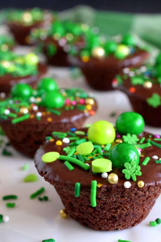 Frosted Two Bite Brownies are for the serious chocolate lover! Dense and moist brownies frosted with the easiest chocolate frosting you'll ever make and topped with sprinkles; you can't eat just one!! #twobite #brownies #frosted #twobitebrownies #stpatricksdayrecipes #greenfood
