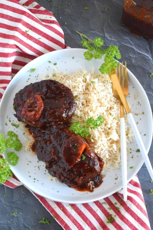 These super moist and tender veal shanks are braised in a rich tomato, white wine, and brown sugar-based sauce. The secret to this delicious Sweet and Savoury Osso Buco, is allowing the meat to cook slowly over low heat in a covered pan for hours. One cannot rush perfection and this osso buco recipe is most certainly perfect! #ossobuco #veal #vealshanks #osso #buco