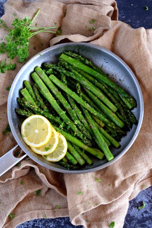 Lemon Butter Asparagus is as simple as it gets - gently sautéed asparagus in a little salted butter with lemon juice, lemon zest, and seasoning. It's a side that is bright and refreshing; a perfect spring and summer side! #asparagus #fresh #saute #skillet #lemon #butter #fried