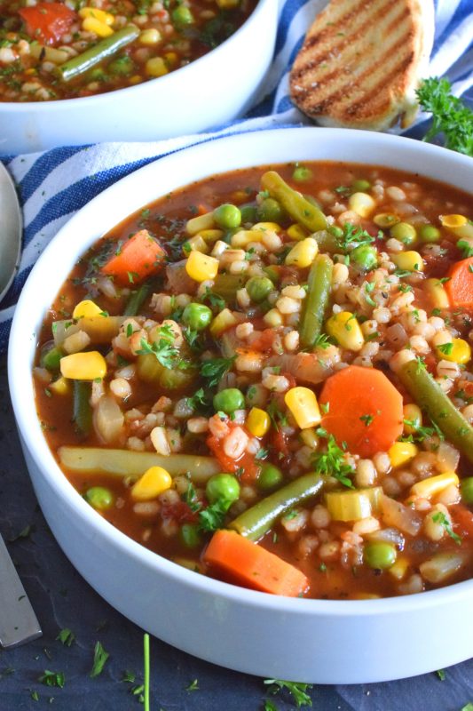 Healthy and hearty soups don’t need to be a bowl of tasteless broth with a few chopped vegetables thrown in for colour!  Pearl Barley Soup is just as delicious as it looks! It is full of good-for-you vegetables and prepared with delicious barley too! #barley #soup #vegetariansoup #barleysoup #pearlbarley