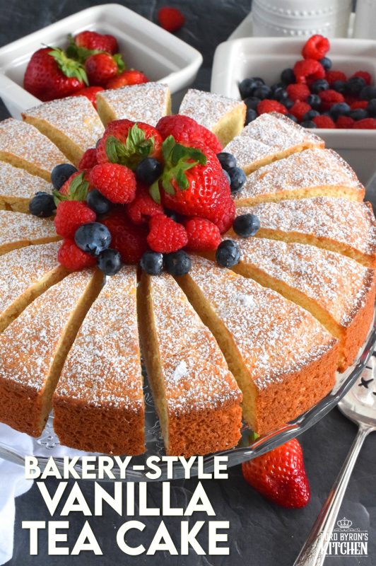 This Bakery Style Vanilla Tea Cake looks superb gussied up with a dusting of confectioner's sugar and a pile of fresh berries. A delightful treat anytime, this cake is the epitome of a beautiful, yet simple, summertime dessert! Bake, slice, and serve with ice cream or whipped cream! #vanillacake #teacake #teatime #bakery