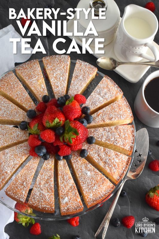 This Bakery Style Vanilla Tea Cake looks superb gussied up with a dusting of confectioner's sugar and a pile of fresh berries. A delightful treat anytime, this cake is the epitome of a beautiful, yet simple, summertime dessert! Bake, slice, and serve with ice cream or whipped cream! #vanillacake #teacake #teatime #bakery