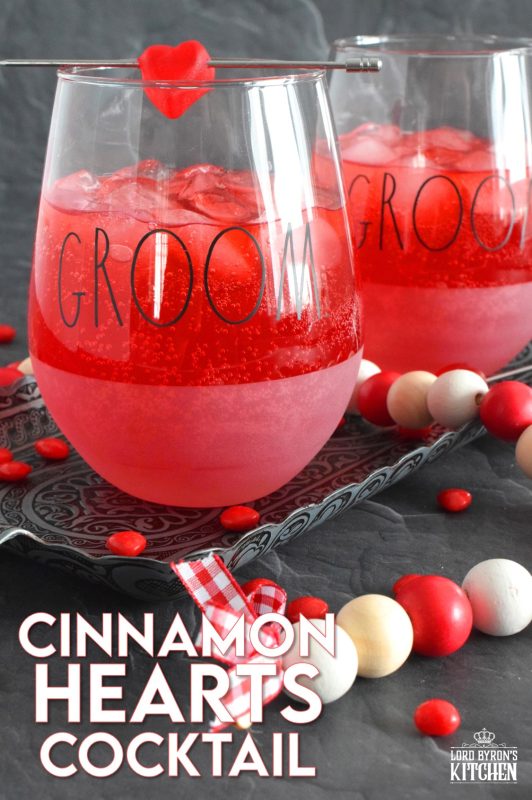 This slightly spicy cocktail is vibrantly red and perfect to share with that special someone on Valentine's Day! Prepared with a homemade, easy-to-make simple syrup made with candy hearts, a good splash of vodka, and club soda, this cocktail is bubbly and has a cozy, warm flavour! #valentines #cocktail #cinnamonhearts #redhots #valentinesday