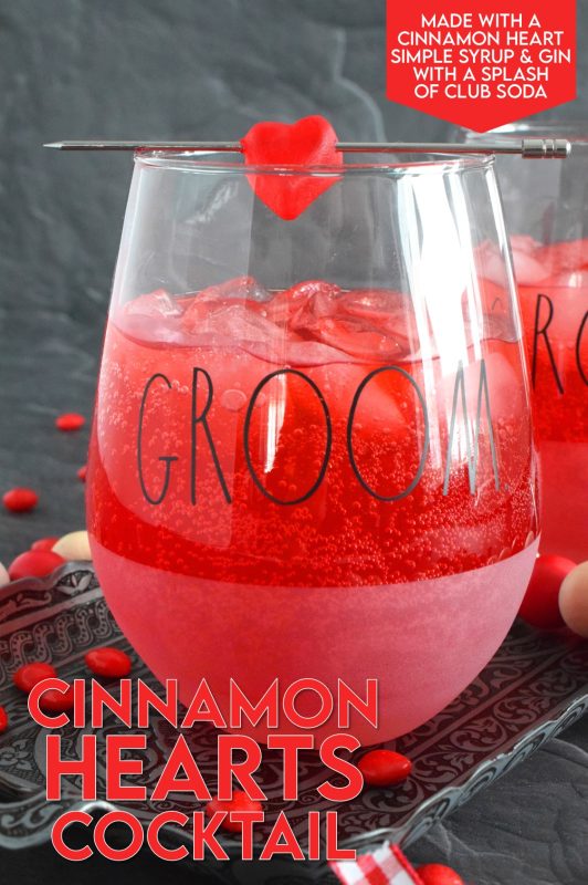 This slightly spicy cocktail is vibrantly red and perfect to share with that special someone on Valentine's Day! Prepared with a homemade, easy-to-make simple syrup made with candy hearts, a good splash of vodka, and club soda, this cocktail is bubbly and has a cozy, warm flavour! #valentines #cocktail #cinnamonhearts #redhots #valentinesday
