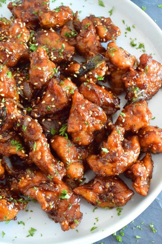 Fried Garlic Chicken is a crispy fried chicken in a thick and savoury garlic sauce; this dish is most certainly for the garlic lover. Prepared with a unique battering technique, and double fried, this chicken is sweet and super garlicky - it's made with twelve cloves of garlic! #garliclovers #garlicky #friedchicken #chicken #thighs