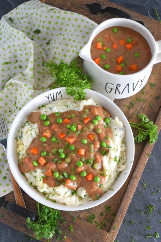 Thick or thin, the choice is yours, but when it comes to Homestyle Gravy with Peas and Carrots, I think thick is best! This easy to make from scratch gravy is deliciously savoury and a perfect vessel to suspend those buttered carrots and peas into! Pour liberally over mashed potatoes and dig in! #gravy #vegetarian #stpattysday #mashedpotatoes