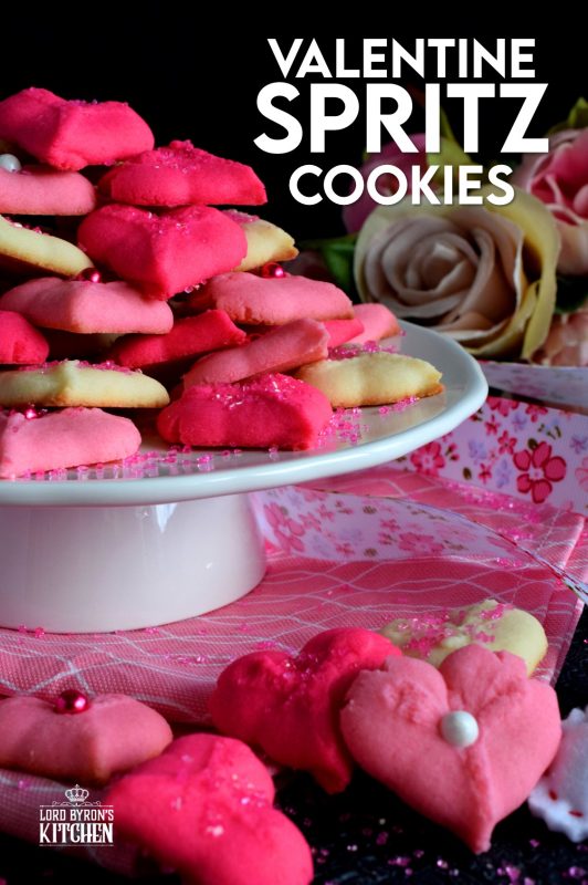 Valentine Spritz Cookies are bright, cheerful, and will bring a smile to anyone's face. These are so easy to make and so delicious too! Break out your sprinkles and have some fun!! #valentinebaking #valentinecookies #pinkrecipes #spritzcookies #cookies #valentinetreats