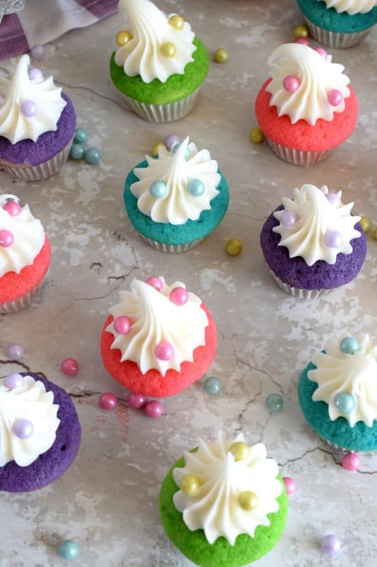 A classic vanilla cupcake recipe, which has been all gussied up for a delightful springtime affair; Bakery Style Mini Vanilla Cupcakes are super easy and fun to make without breaking the bank. #minicupcakes #bakerystyle #vanillacupcakes #birthdaycupcakes