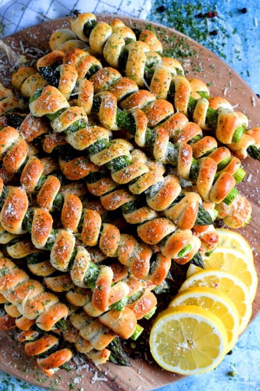 Whether you're looking for a new side dish or an interesting appetizer, Wrapped Asparagus with Garlic Butter and Parmesan is the answer. Perfectly baked, perfectly seasoned, and perfectly perfect! Serve hot or at room temperature! #asparagus #wrapped #appetizer #homemade #dough #biscuit #dip #baked #roasted