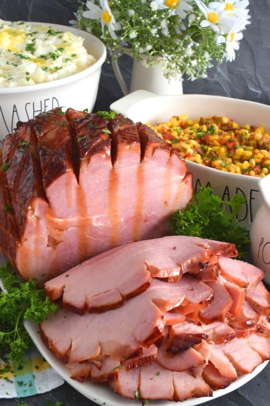 Take all of the guesswork out of preparing a large ham with this recipe! Brown Sugar Mustard Glazed Virginia Ham is easy to prepare and it looks incredible! This ham is perfectly baked, is moist and tender, and has a sweet and sticky glaze with just a little bite to it - you will hope for leftovers because this ham is too good to not have some the next day! #virginiaham #countryham #ham #glazedham #bakedham