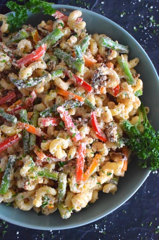 Served cold or at room temperature, Greek Yogurt Asparagus Pepper Pasta Salad is bound to be a new family favourite. Creamy, zingy, and cheesy, this salad is one you will want to make over and over again! #pasta #pastasalad #asparagus #vegetablesalad #vegetarian #potluck #summersalad