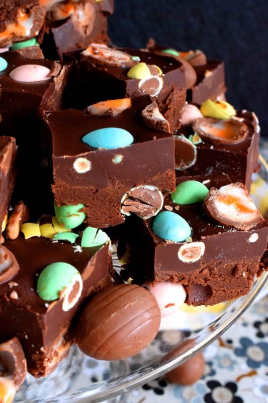 Cadbury Creme and Mini Egg Fudge is a dense chocolate fudge loaded with both creme eggs and mini eggs. It's an easy and perfect Easter chocolate indulgence. Try eating just one piece; I dare you! #fudge #easter #easterchocolate #cadbury #cremeeggs