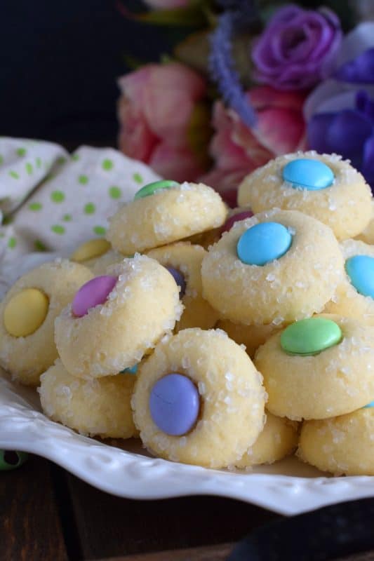Miniature, one-bite cookies made with pastel candy centers. Easter Bunny Button Cookies are a great Easter gift idea, and can be easily packaged for gift-giving, or just save them all for yourself! Whatever you decide, a double batch just might be a good idea! #easter #bunny #cookies #candy #chocolate