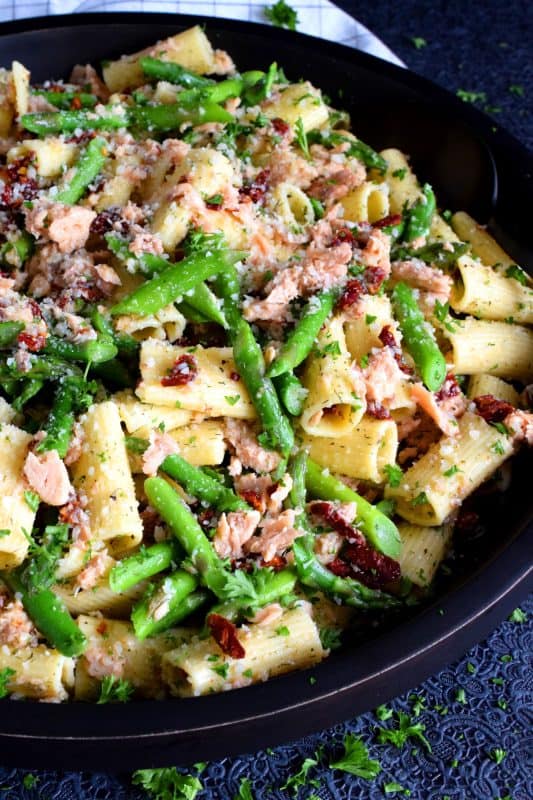 Served warm or hot, Salmon and Asparagus Pasta Salad is a complete meal with so much flavour and texture! The fresh asparagus, lemon juice, and freshly grated parmesan cheese come together to elevate the inexpensive and humble canned flaked salmon! #canned #salmon #asparagus #salad #costco