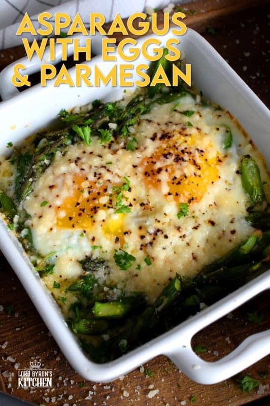 Simple, hearty, and delicious; individual portions make these Baked Asparagus with Eggs and Parmesan easy to serve and a little elegant too! This is exactly how I serve asparagus as a main! Dip some crusty bread in the soft yolks - it's scrumptious!! #baked #asparagus #egg #parmesan #brunch