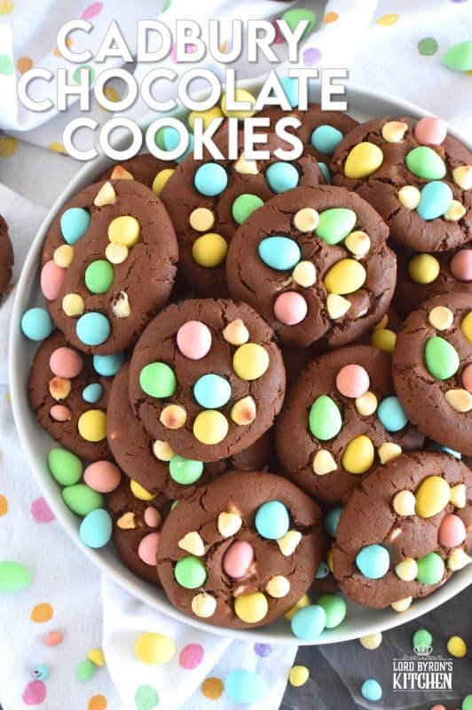 Cadbury Chocolate Cookies are slightly crispy on the outside, with a moist and dense chocolaty center. Stuffed with white chocolate chips and topped with chocolate mini eggs, these are substantial cookies, meaning that they are thick and filling. Great for dunking in a glass of cold milk too! #cadbury #minieggs #easter #cookies #chocolate