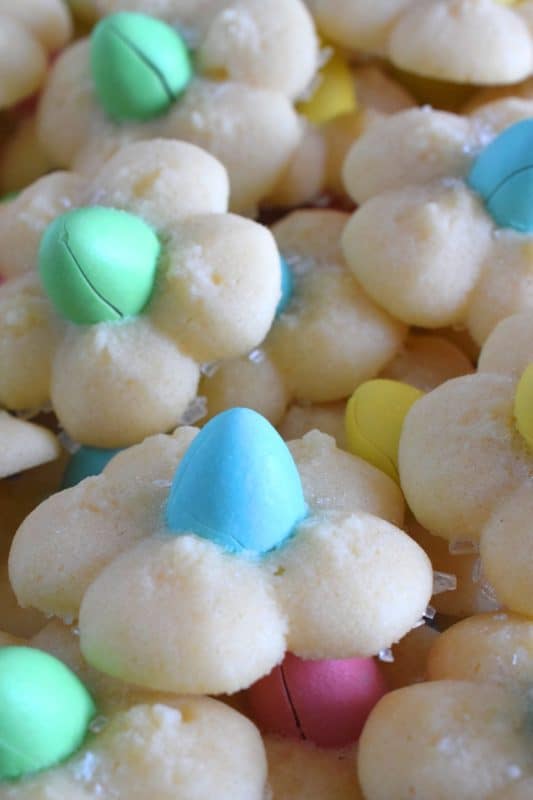 A good spritz cookie should taste slightly sweet and buttery. The cookie should be slightly crumbly, but not dry, and it should feel like it’s melting in your mouth. Topped with a single candy-coated chocolate, these Springtime Flower Cookies are not only delicious but pretty and cheerful too! #spritz #cookies #easter #spring #flower #cadbury #minieggs