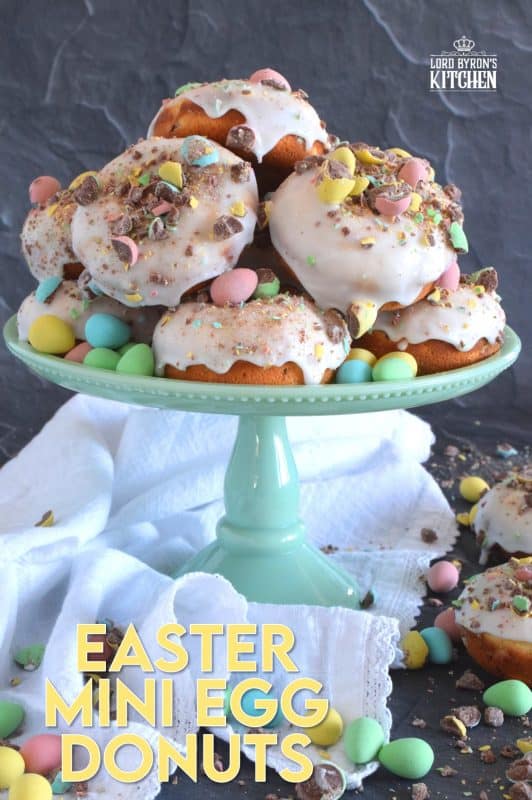 When it comes to donuts, chocolate is always a great choice. Easter Mini Egg Donuts are prepared with a vanilla batter, loaded with crushed Cadbury mini eggs, topped with a simple sugar glaze, and more crushed mini eggs! Easter treats never tasted so good! #donuts #bakeddonuts #doughnuts #easter #cadbury #minieggs