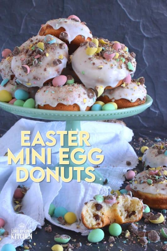 When it comes to donuts, chocolate is always a great choice. Easter Mini Egg Donuts are prepared with a vanilla batter, loaded with crushed Cadbury mini eggs, topped with a simple sugar glaze, and more crushed mini eggs! Easter treats never tasted so good! #donuts #bakeddonuts #doughnuts #easter #cadbury #minieggs