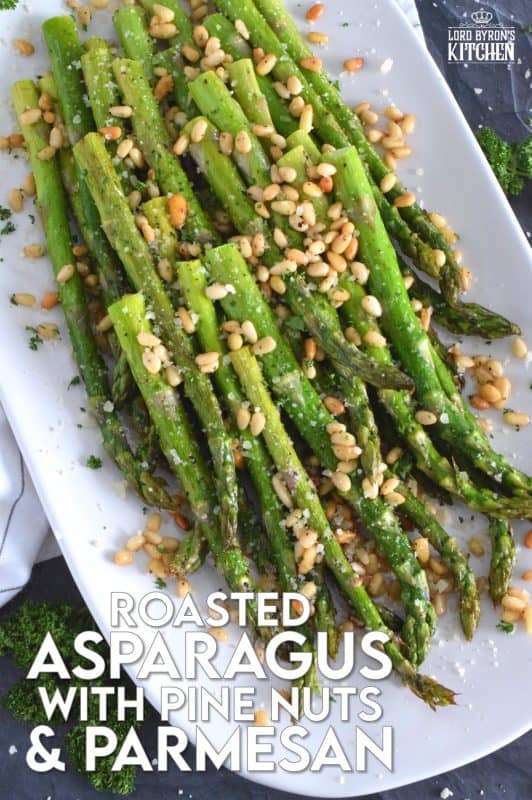 This side dish is great any time, but is best when fresh asparagus is in season. Roasted Asparagus with Pine Nuts and Parmesan has perfectly cooked asparagus with the saltiness of freshly grated parmesan and the nuttiness of delicately toasted pine nuts. Super fast, super yummy, and super easy! #asparagus #pinenuts #parmesan #roasted #sidedish