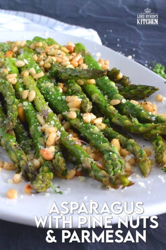 This side dish is great any time, but is best when fresh asparagus is in season. Roasted Asparagus with Pine Nuts and Parmesan has perfectly cooked asparagus with the saltiness of freshly grated parmesan and the nuttiness of delicately toasted pine nuts. Super fast, super yummy, and super easy! #asparagus #pinenuts #parmesan #roasted #sidedish