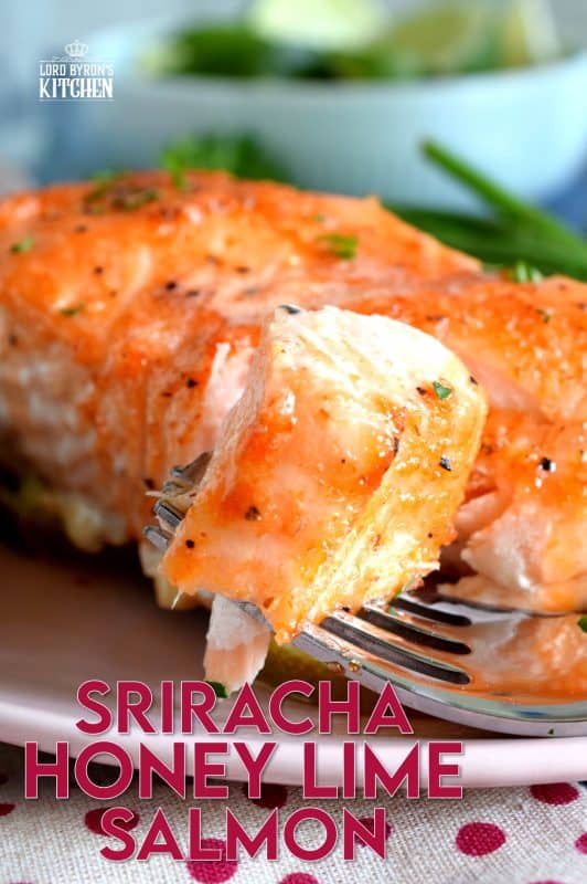 Slightly sweet with a little tartness, Sriracha Honey Lime Salmon is oven baked on a bed of sliced limes for extra zing and fresh flavour. The sriracha and honey combine to make a wonderful basting sauce with the perfect balance of sweet and heat. #sriracha #honey #honeylime #salmon #bakedsalmon #spicysalmon