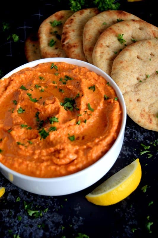Probably the most common and recognizable hummus, Roasted Red Pepper Hummus packs a punch of deep smoky flavour with a burst of lemon freshness and the warmth of fresh garlic!  A great flavour to start with if the world of homemade hummus is new to you! #hummus #homemade #dip #spreads #redpepper #roasted #roastedredpeppers