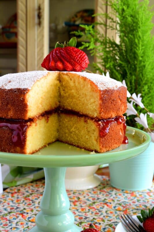 This gorgeous, easy-to-prepare, homemade Jam Filled Vanilla Layer Cake is not only delicious but also quite impressive! Although basic and rustic in presentation, this cake looks like a million bucks! No cake-decorating skills are needed for this beautiful showpiece! And, as a bonus, you can use your favourite jam flavour too! #jam #filling #cake #vanilla #easy #center