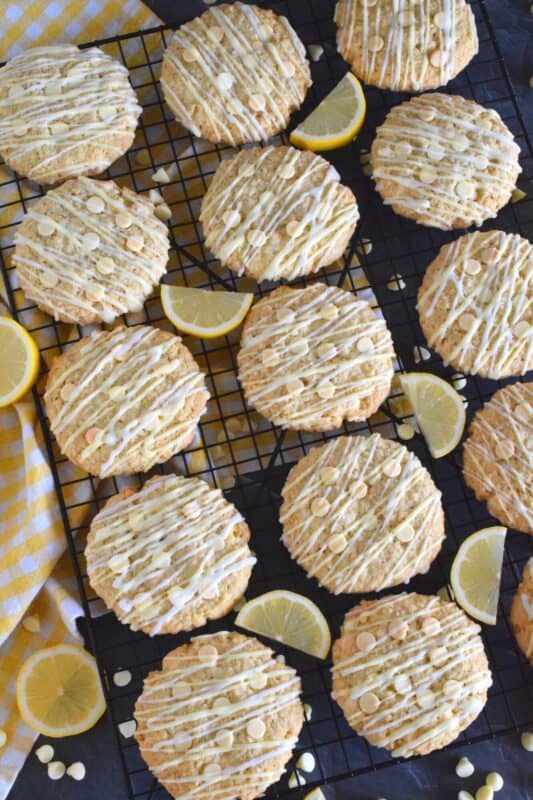 These cookies are both sweet and tart, and completely indulgent too! The flavour combination is created by pairing lemon zest and juice with oats, sugar, white chocolate chips, and vanilla pudding mix! Lemon Glazed Oatmeal White Chocolate Cookies are massively large, soft and chewy, and absolutely delicious! #lemon #oatmealcookies #cookies #glazed #tart #pudding