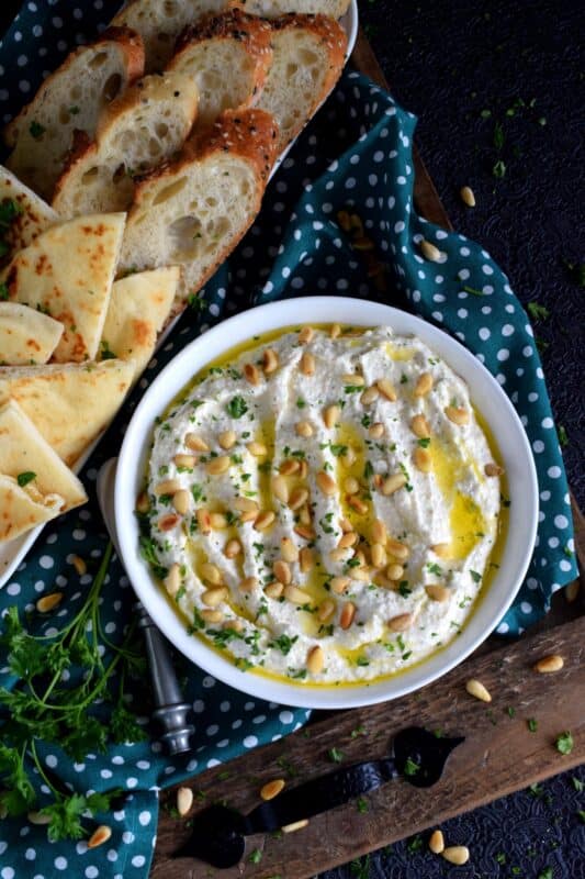 Salty and velvety smooth, seasoned with pantry herbs and spices, Creamy Whipped Feta will satisfy all of your snack cravings. Smear it on crackers and bread, or use it as a dip with veggies or pita. For even more flavour, be sure to toast the pine nuts first! #feta #fetadip #whippedfeta #dip #spread #appetizer