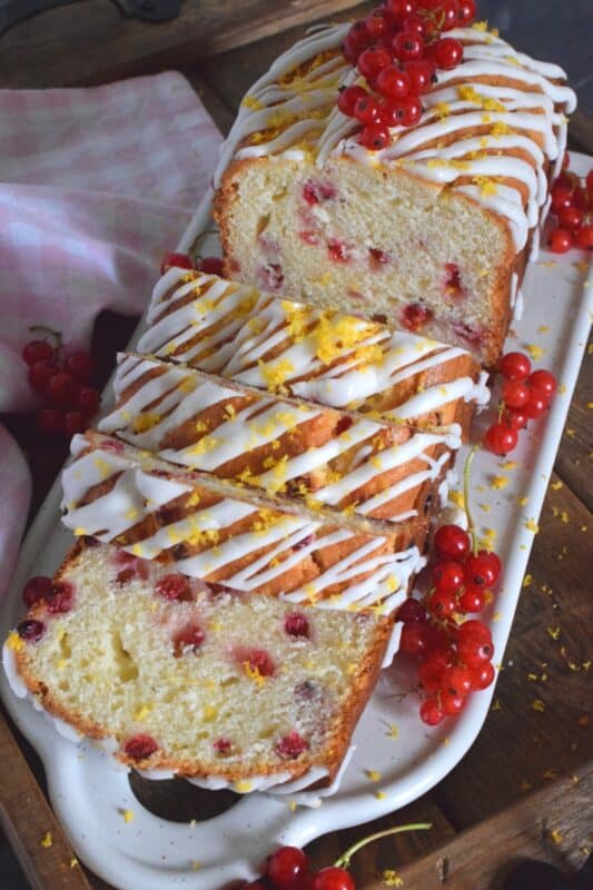 Moist and delicious, lemony and refreshing, packed with berries, and drizzled with a sweet glaze, Red Currant Lemon Loaf is a perfect dessert, or a lovely addition to your afternoon tea. This is a summertime brunch item that doubles as an evening after dinner dessert. #glazed #lemon #loaf #berries #red #currants #zest