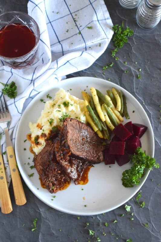 Succulent and moist, and slowly braised with onions and a delicious homemade broth consisting of brewed coffee, Beef Sirloin Tip Roast is delicious and a perfect meal for the entire family! Slow cooking and locking in moisture is the key to a tender, fall-apart roasted beef sirloin dinner! #sirloin #braised #beef #sunday #family #dinner