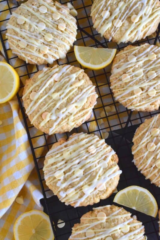 These cookies are both sweet and tart, and completely indulgent too! The flavour combination is created by pairing lemon zest and juice with oats, sugar, white chocolate chips, and vanilla pudding mix! Lemon Glazed Oatmeal White Chocolate Cookies are massively large, soft and chewy, and absolutely delicious! #lemon #oatmealcookies #cookies #glazed #tart #pudding