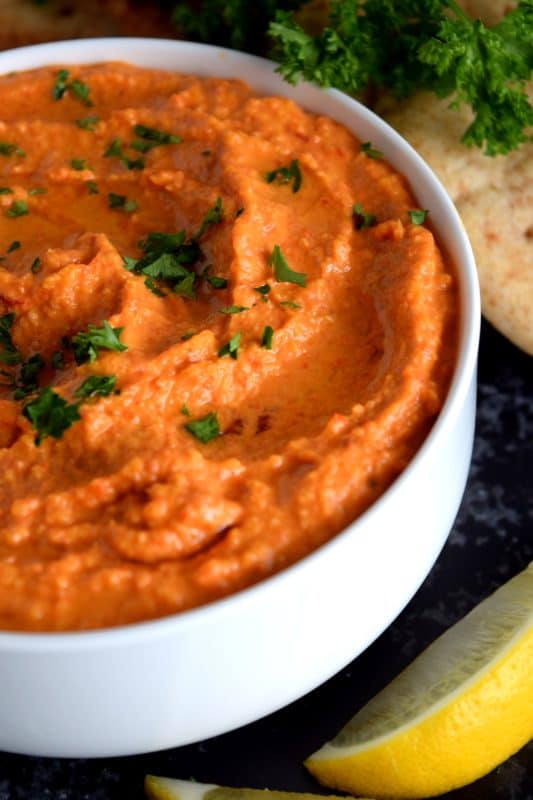 Probably the most common and recognizable hummus, Roasted Red Pepper Hummus packs a punch of deep smoky flavour with a burst of lemon freshness and the warmth of fresh garlic!  A great flavour to start with if the world of homemade hummus is new to you! #hummus #homemade #dip #spreads #redpepper #roasted #roastedredpeppers