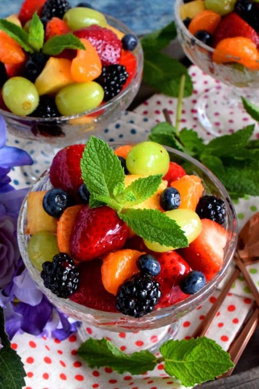 Fruit and Berry Salad is always best when comprised of fruit and berries that are currently in season, but there are certainly no die-hard rules; after all, rules were made to be broken! Use a sugar-free jelly to give your fruit that glossy, shiny look!! #fruitsalad #fruitbowl #choppedfruit #glazedfruitsalad #summerfruit #berries #fruitsandberries